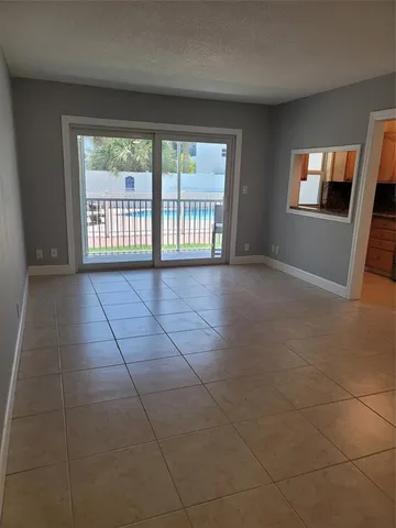 a kitchen with cabinets stainless steel appliances and a window