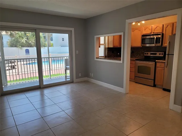 an empty room with closet and a bathroom