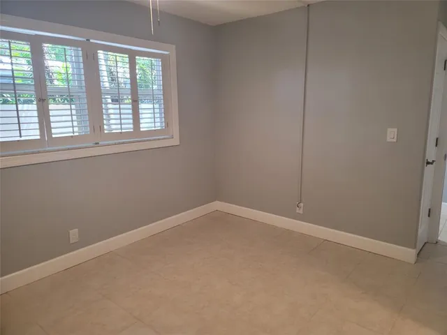 a view of an empty room and a bathroom