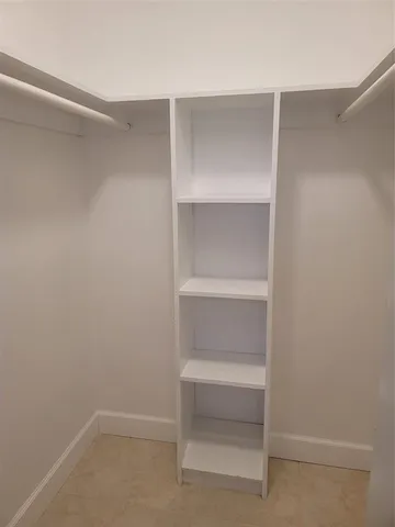 a view of a swimming pool with lawn chairs and a big yard