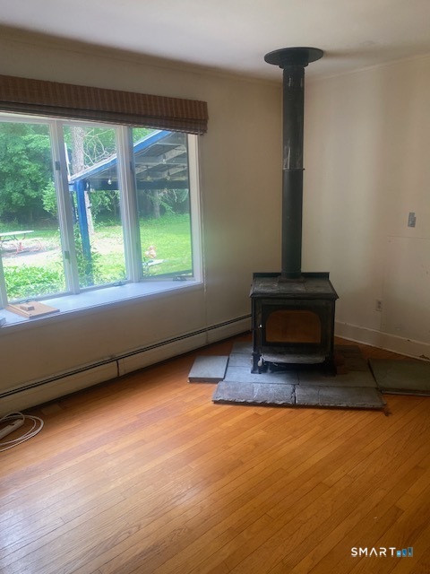 33 Flanders Road Bethlehem, CT 06751 - Photo 8 of 18 a living room with furniture floor to ceiling window and wooden floor