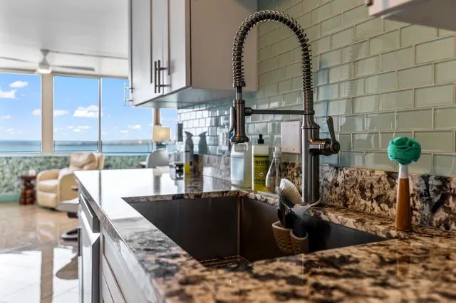 a view of a kitchen with a sink and cabinets