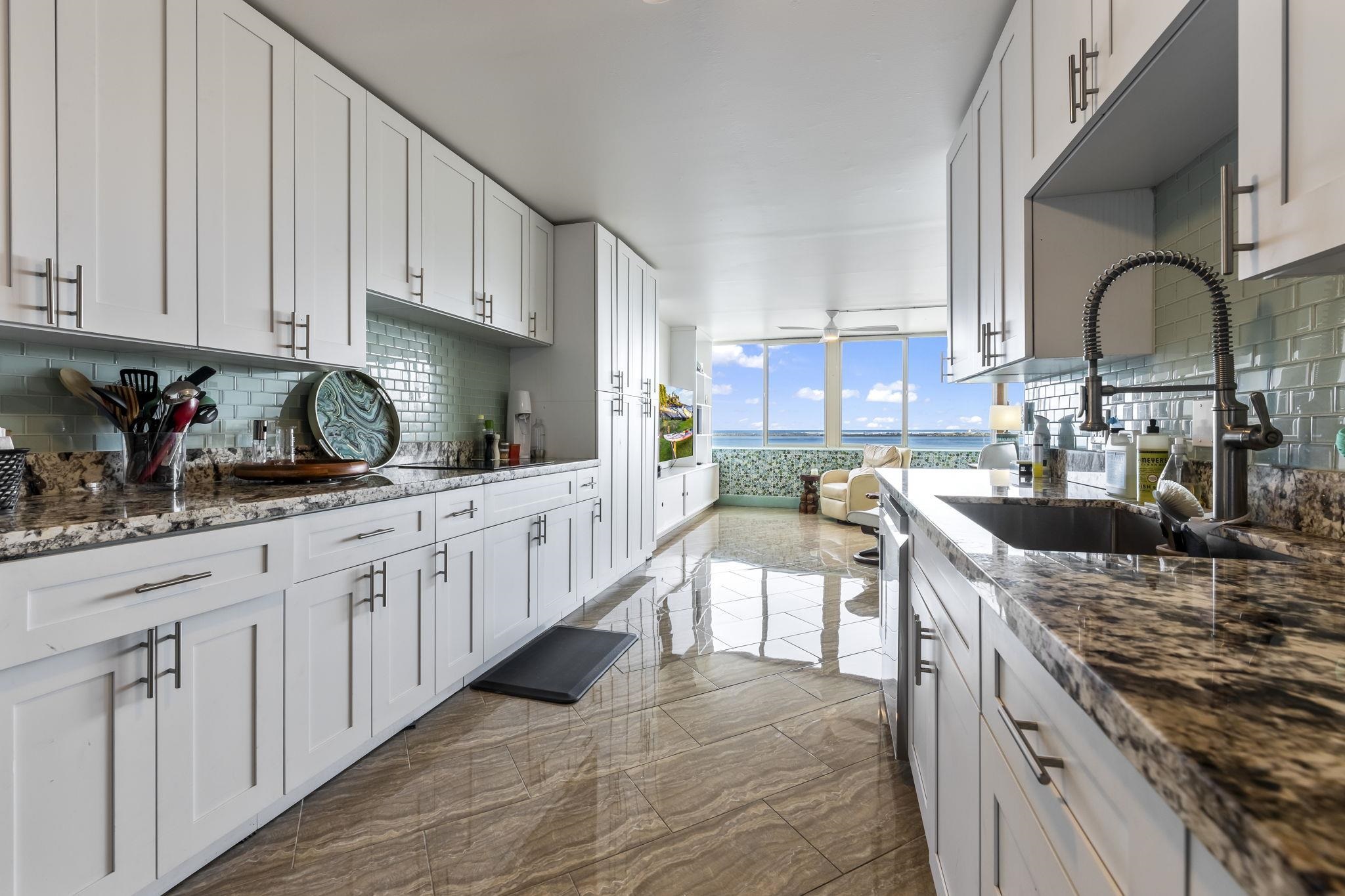 111 Kahului Beach Road, Unit A426 Kahului, HI 96732 - Photo 2 of 24 a kitchen with stainless steel appliances granite countertop a stove a sink dishwasher and cabinets with wooden floor