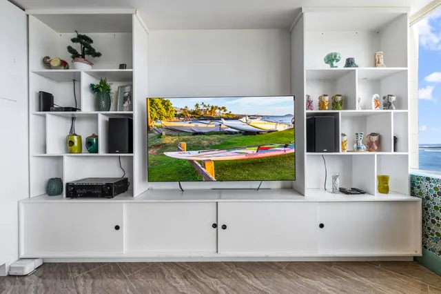 a living room with furniture and a book shelf