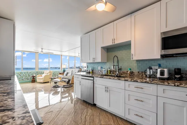 a kitchen with a sink a stove and cabinets