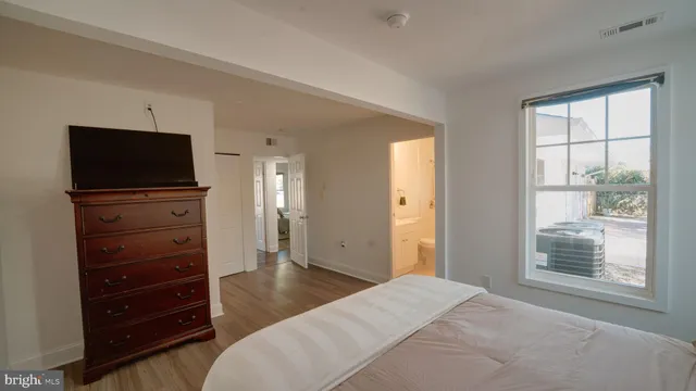 a bedroom with a bed and a television