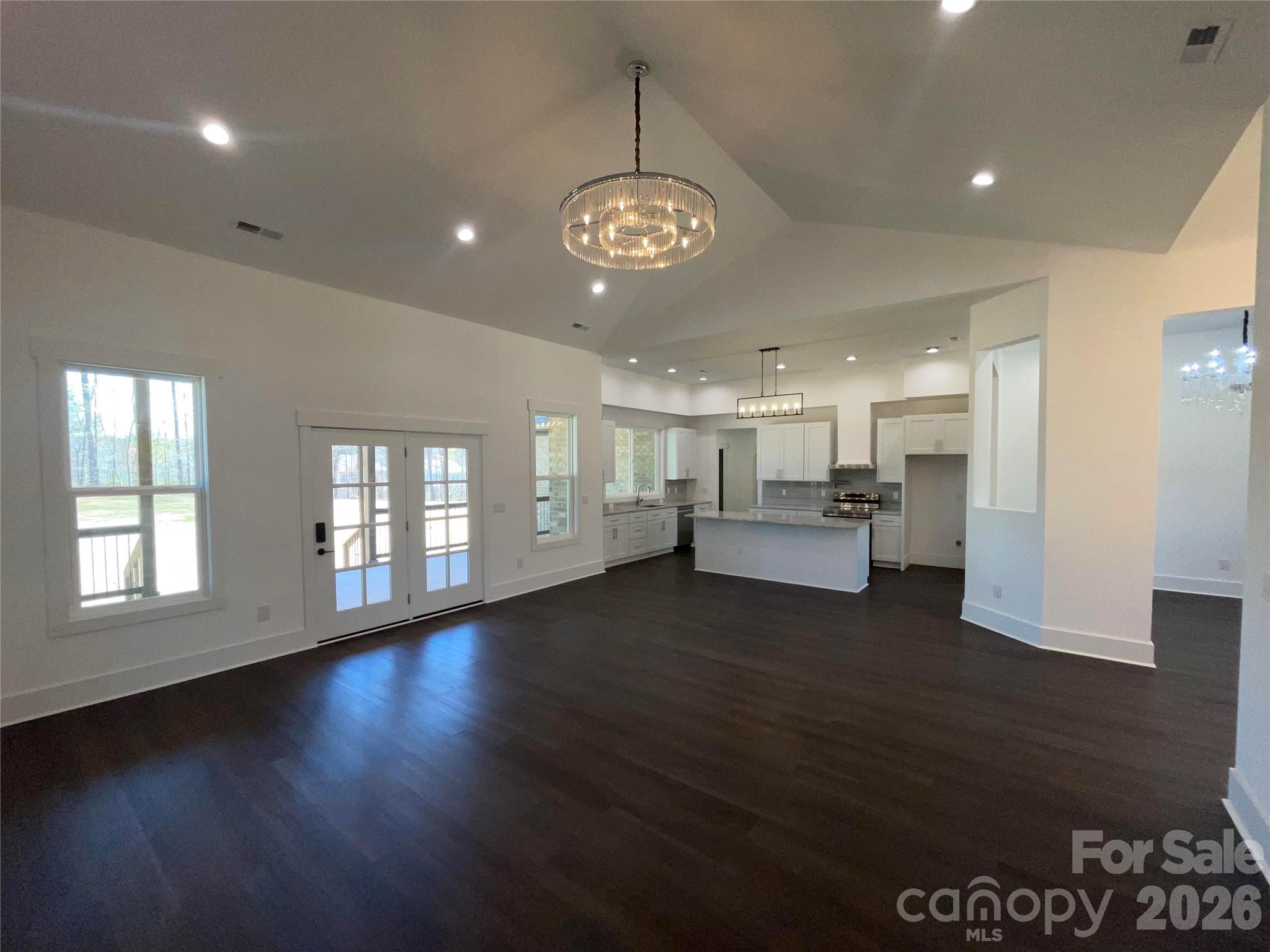 321 Stone Ridge Drive Salisbury, NC 28146 - Photo 9 of 39 a view of an empty room with wooden floor and windows