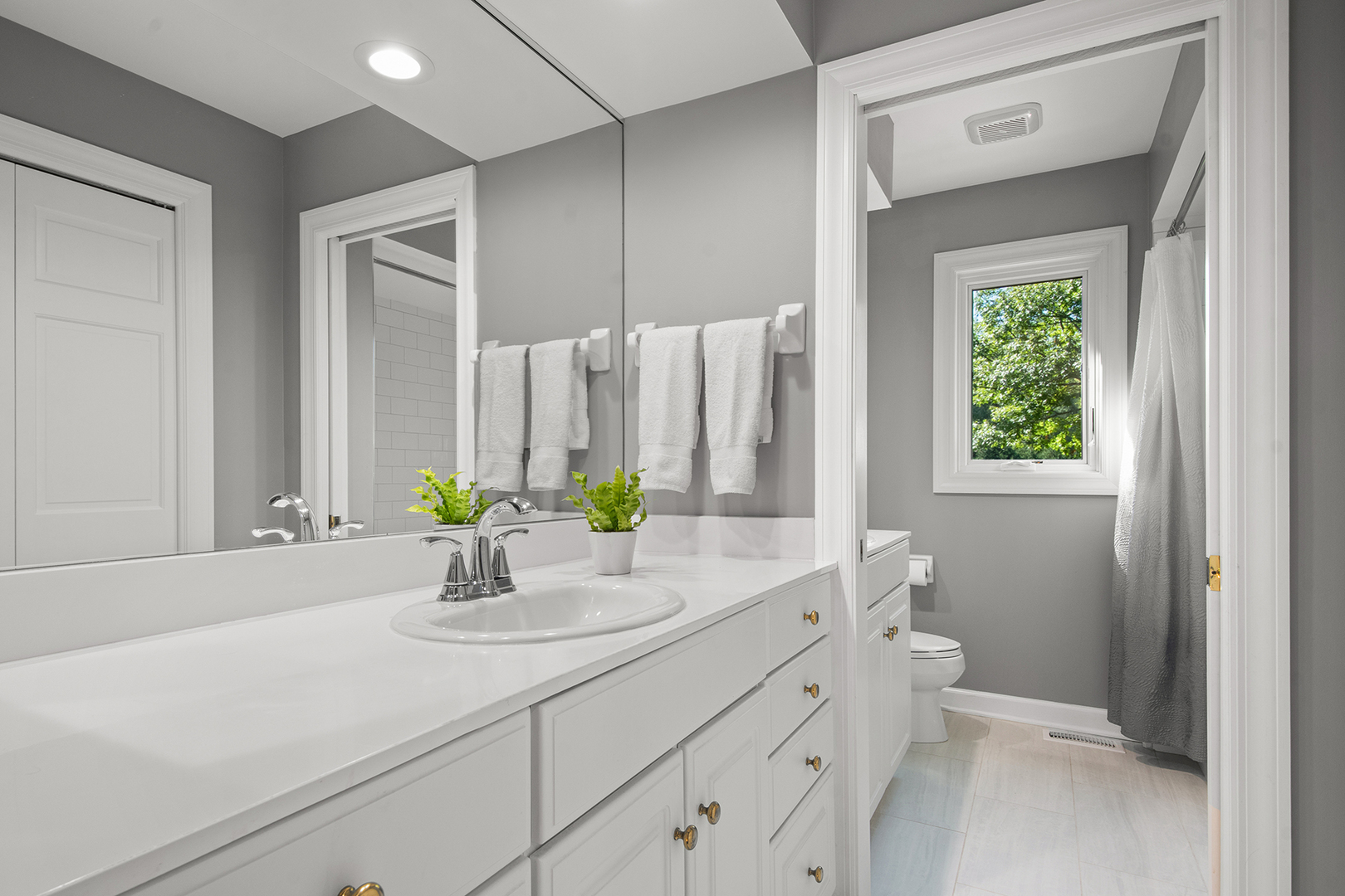 100 Boardman Court Lake Bluff, IL 60044 - Photo 27 of 33 a bathroom with a sink a toilet and a mirror