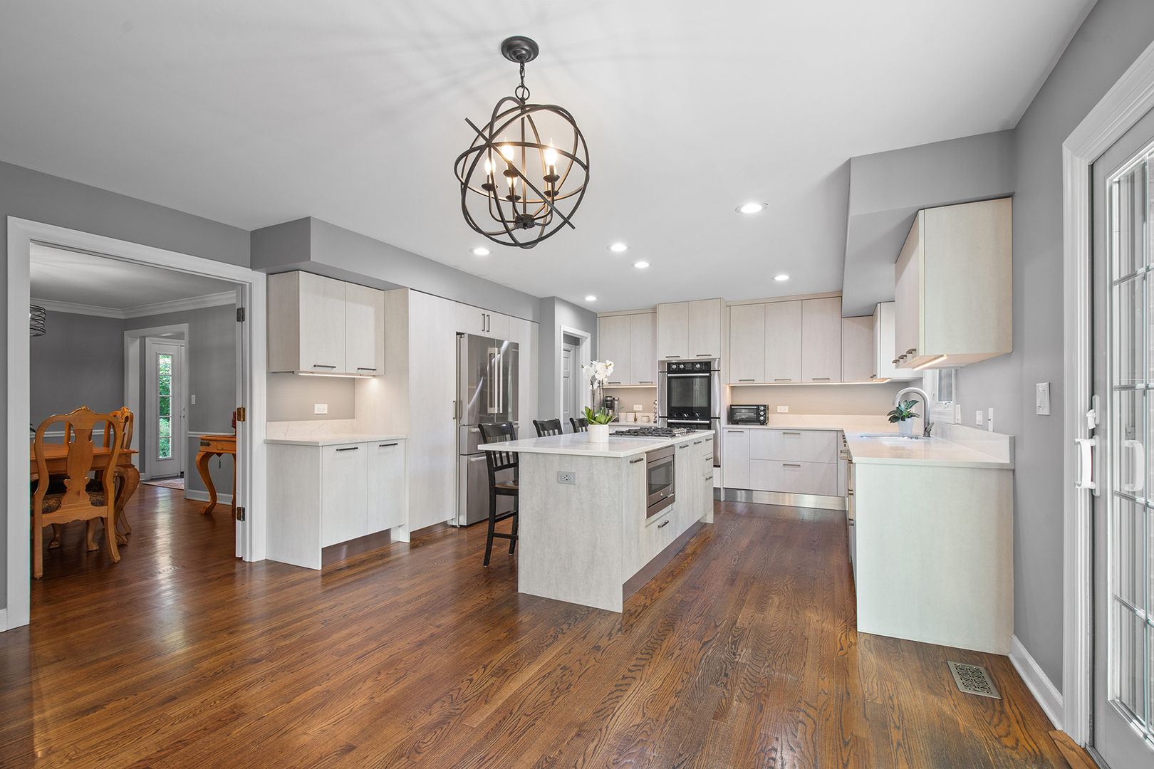 100 Boardman Court Lake Bluff, IL 60044 - Photo 8 of 33 a kitchen with a refrigerator and white cabinets