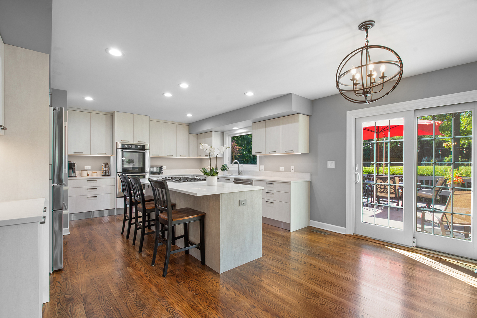 100 Boardman Court Lake Bluff, IL 60044 - Photo 9 of 33 an open dining room with wooden floor a chandelier a wooden table and chairs