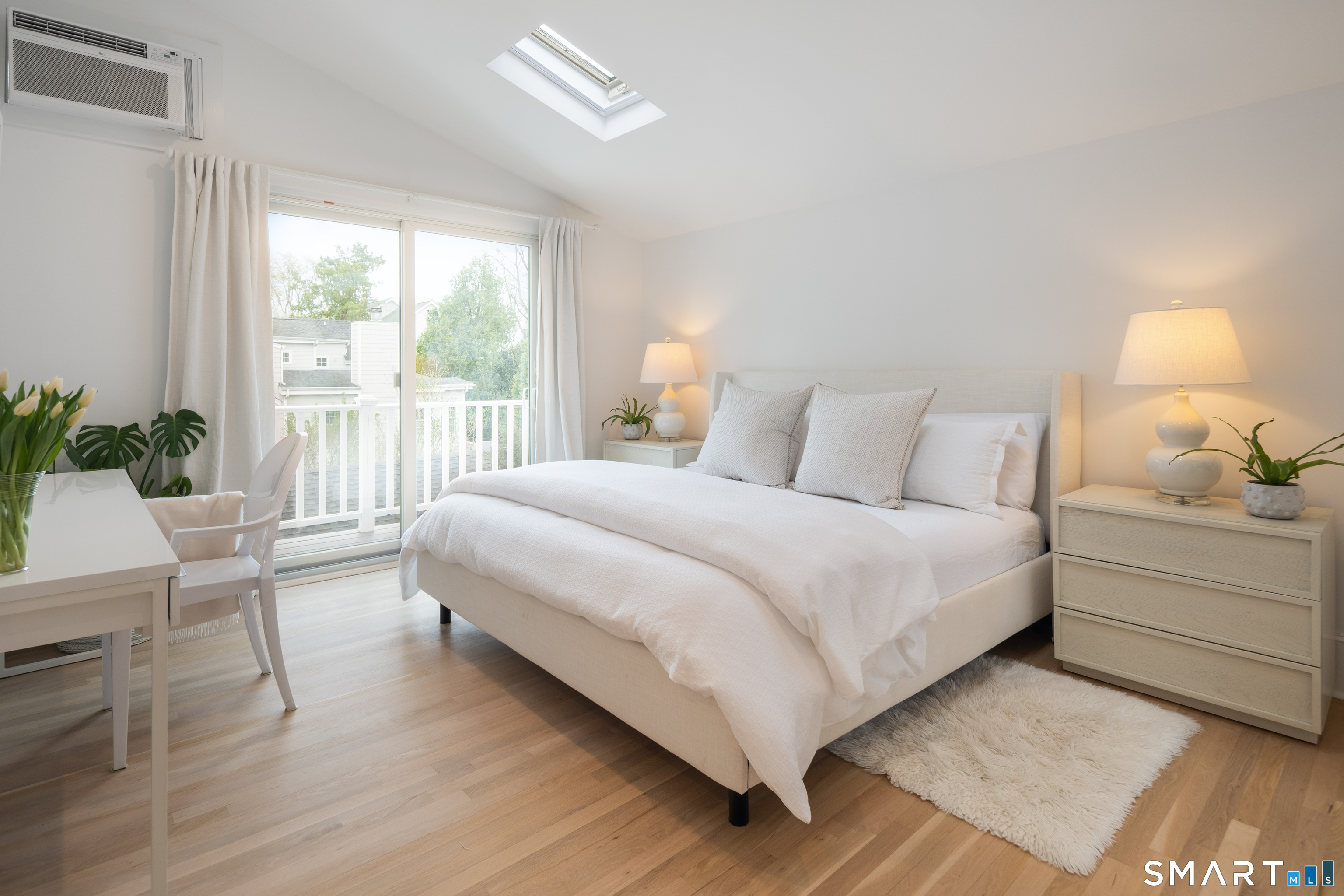 26 Flicker Lane Norwalk, CT 06853 - Photo 17 of 26 a bedroom with a bed and a lamp on table
