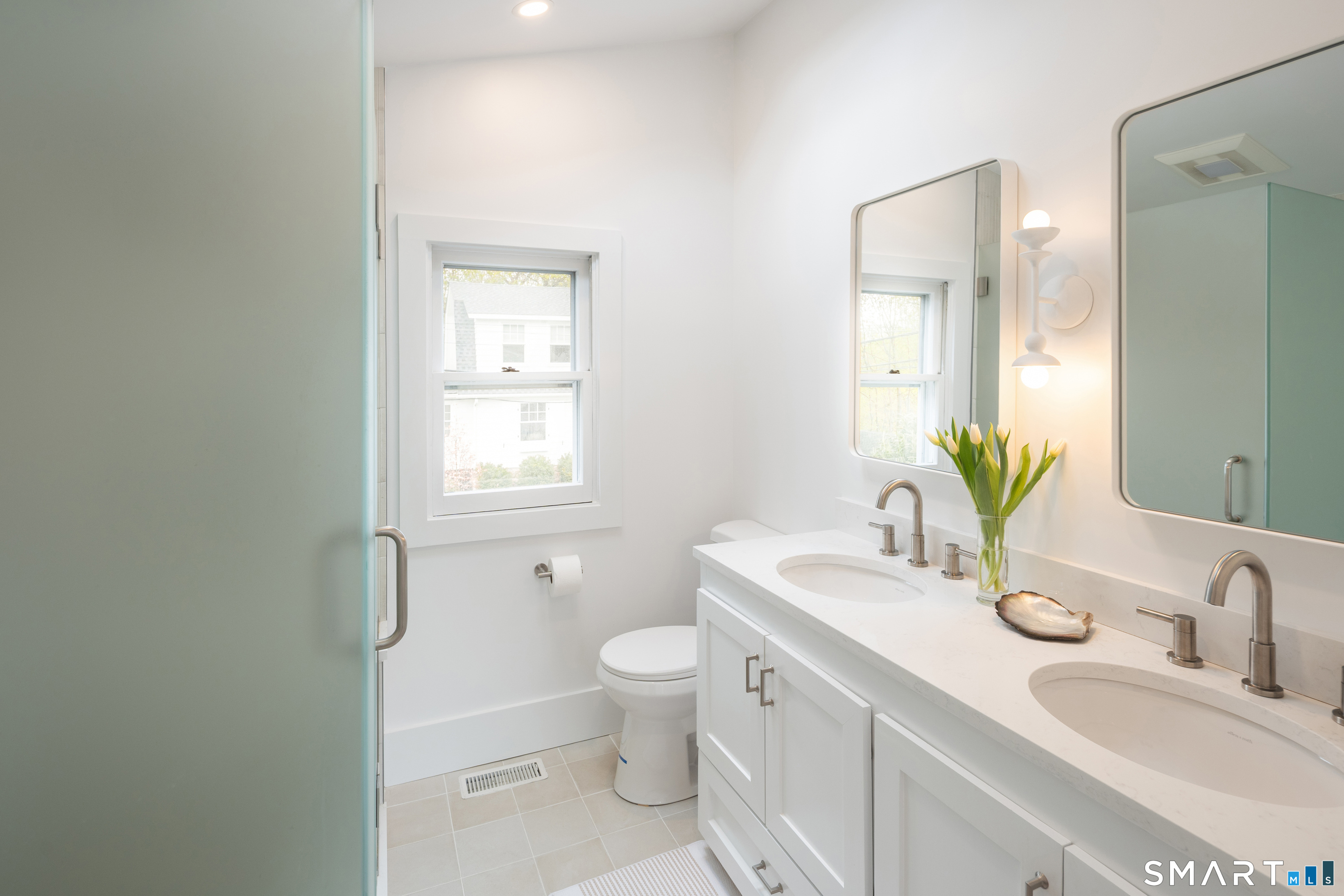 26 Flicker Lane Norwalk, CT 06853 - Photo 18 of 26 a bathroom with a granite countertop sink a toilet and a mirror