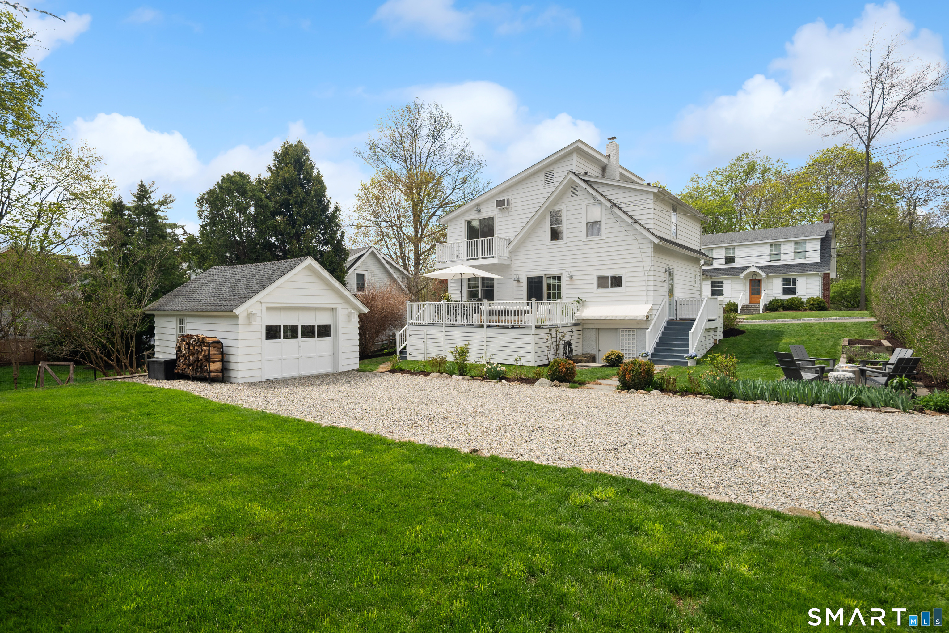 26 Flicker Lane Norwalk, CT 06853 - Photo 24 of 26 a front view of a house with a yard and garage
