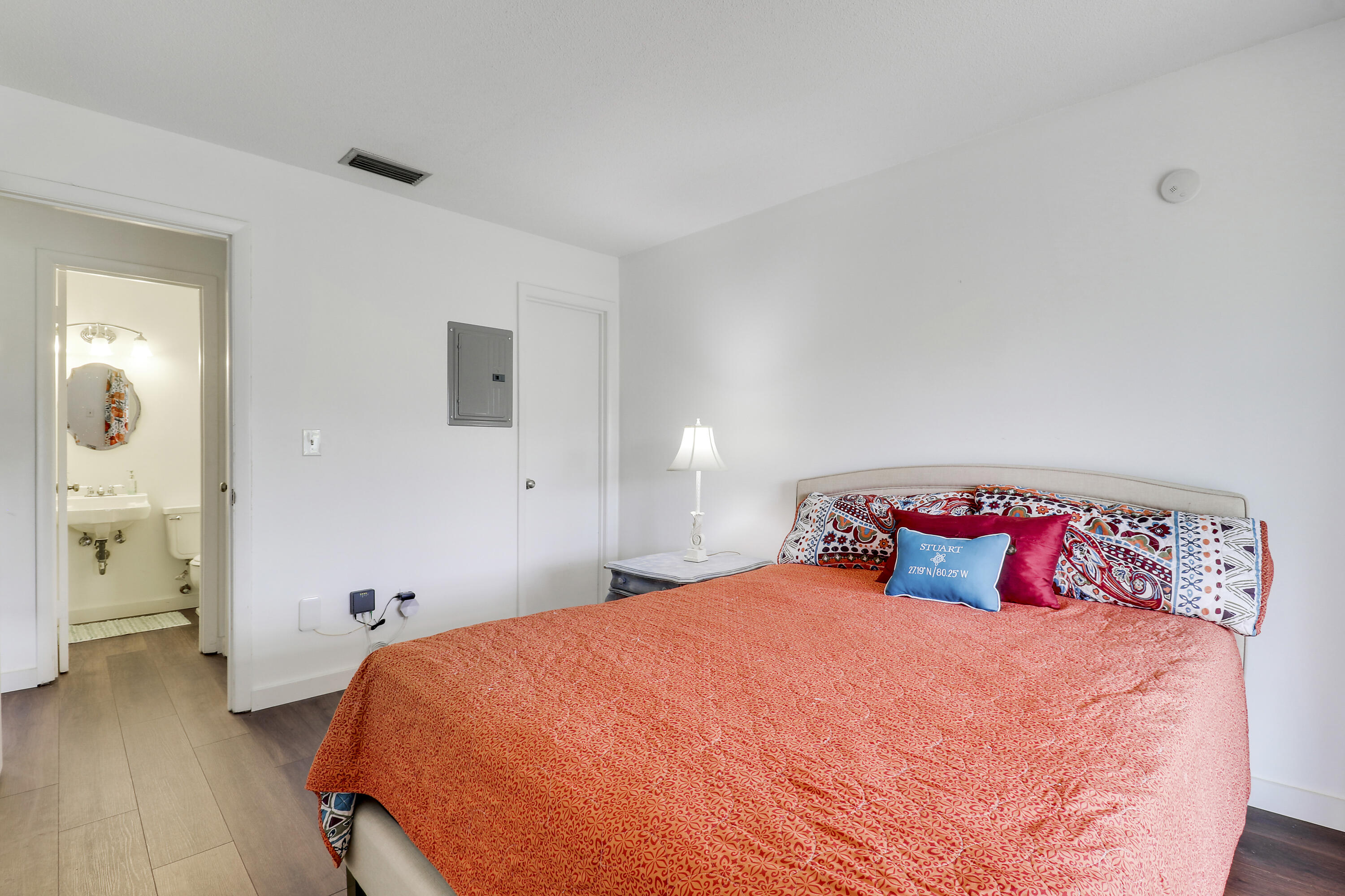 2929 Southeast Ocean Boulevard, Unit 19 Stuart, FL 34996 - Photo 15 of 19 a bedroom with a bed and wooden floor