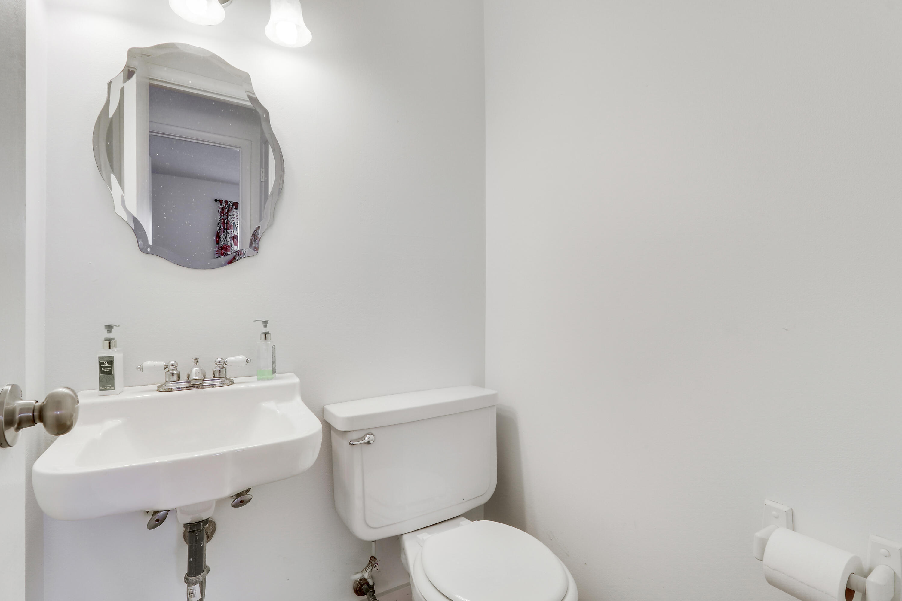 2929 Southeast Ocean Boulevard, Unit 19 Stuart, FL 34996 - Photo 17 of 19 a bathroom with a toilet a sink and mirror