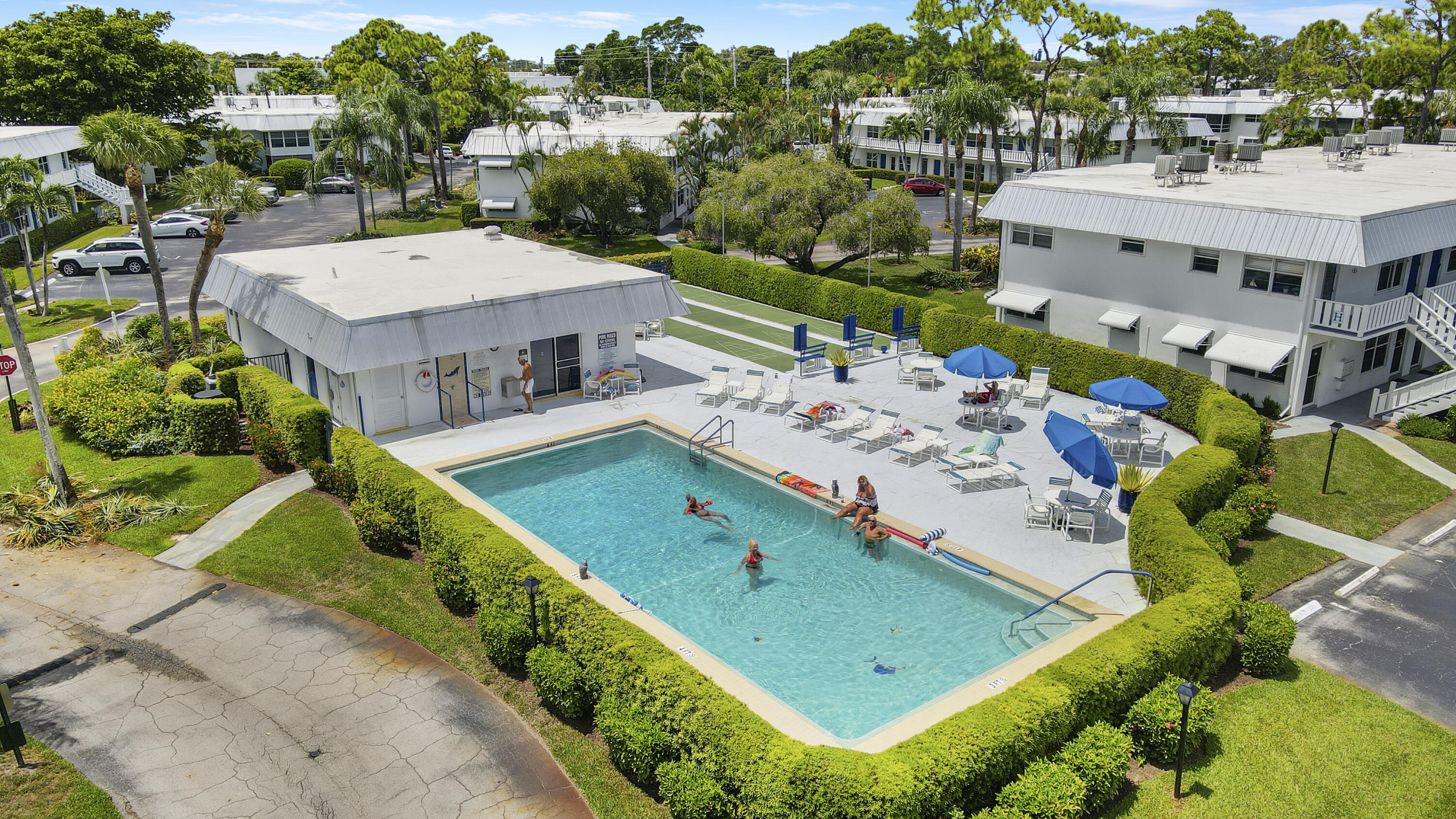 2929 Southeast Ocean Boulevard, Unit 19 Stuart, FL 34996 - Photo 18 of 19 an aerial view of a tennis ground and large trees