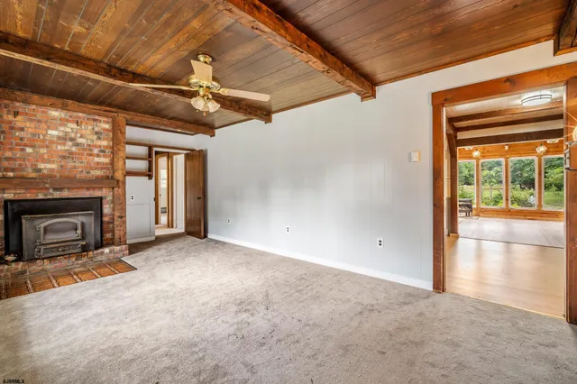 a view of a livingroom with a fireplace and window