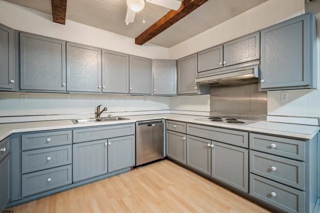 a kitchen with cabinets appliances and a sink