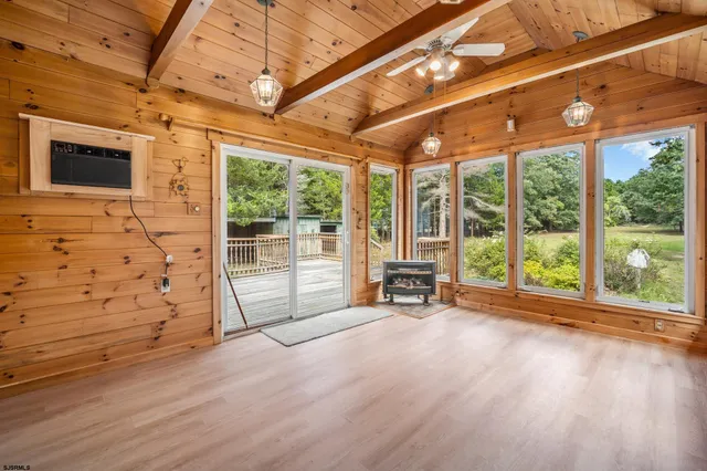 a view of a room with wooden floor and outdoor space