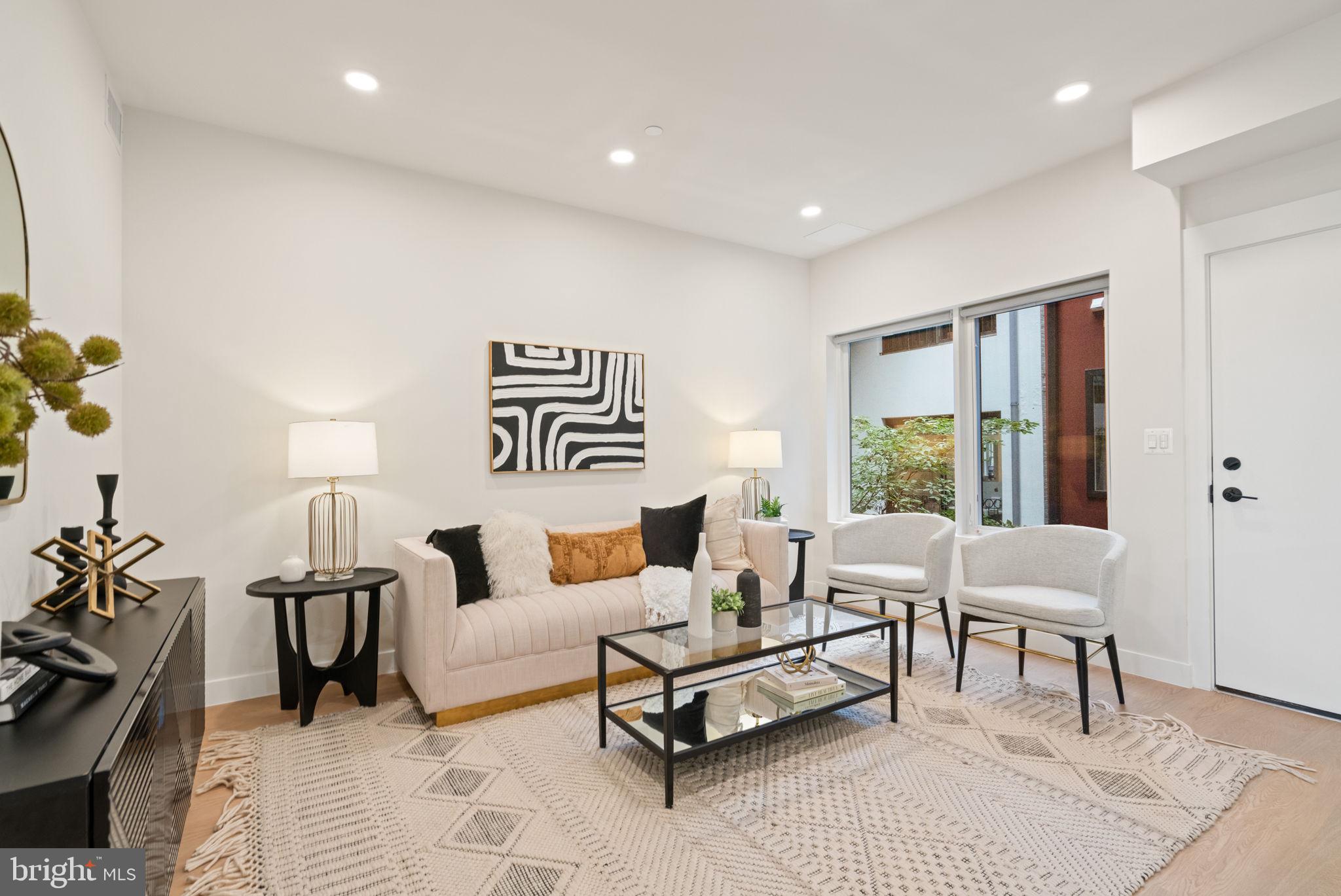 733 8th Street Southeast, Unit 1 Washington, DC 20003 - Photo 5 of 11 a living room with furniture and a large window