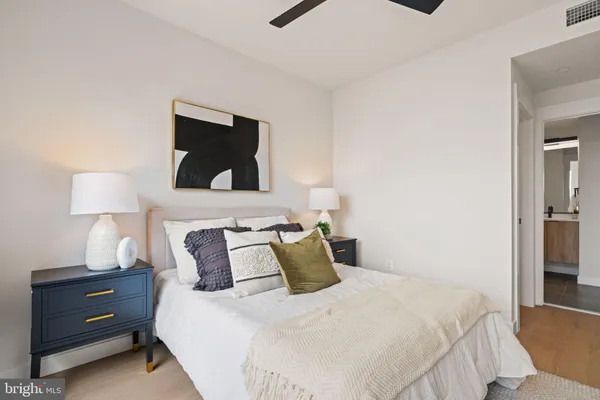 a bedroom with a bed and a night stand