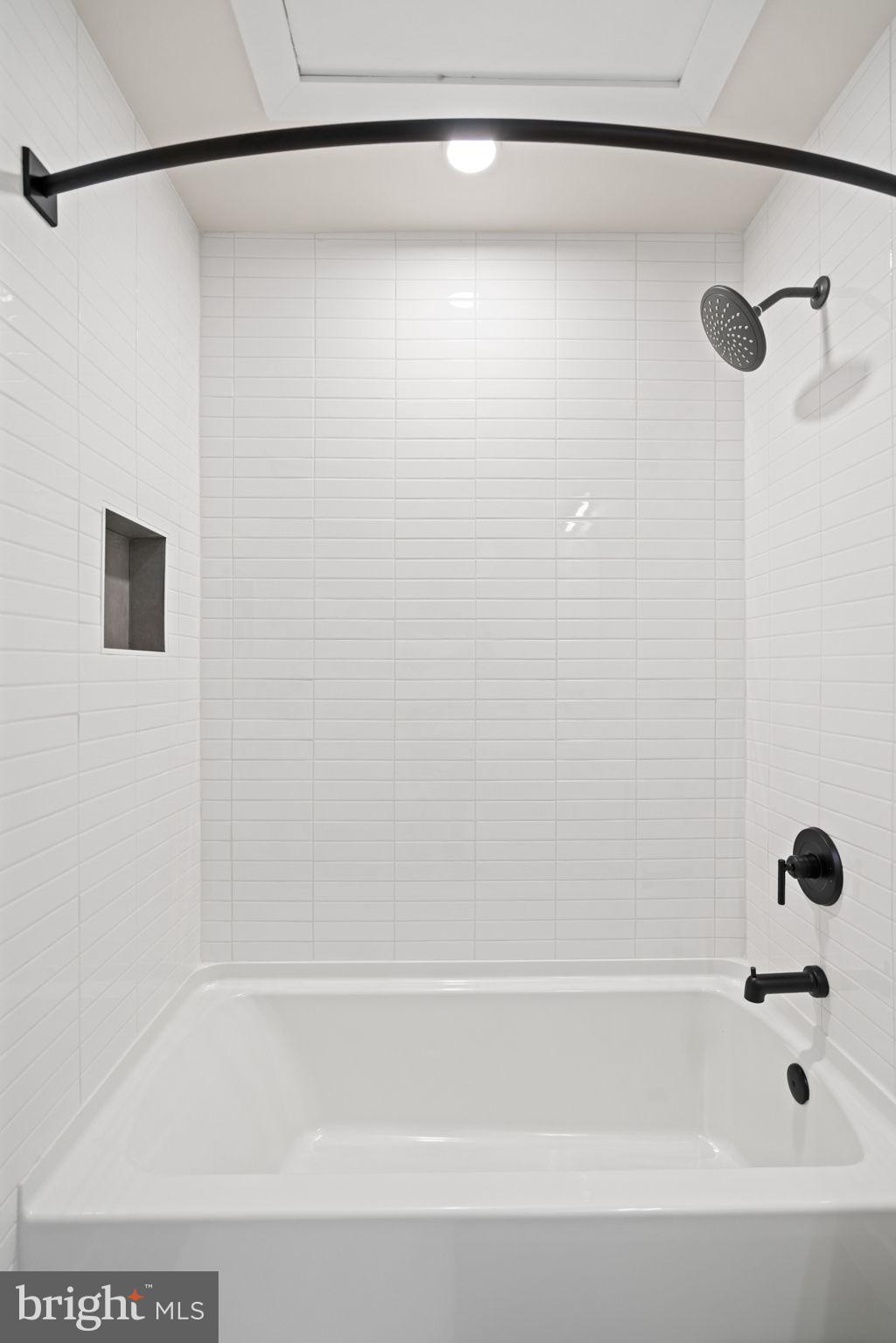 733 8th Street Southeast, Unit 1 Washington, DC 20003 - Photo 10 of 11 a bathroom with a shower and a bath tub