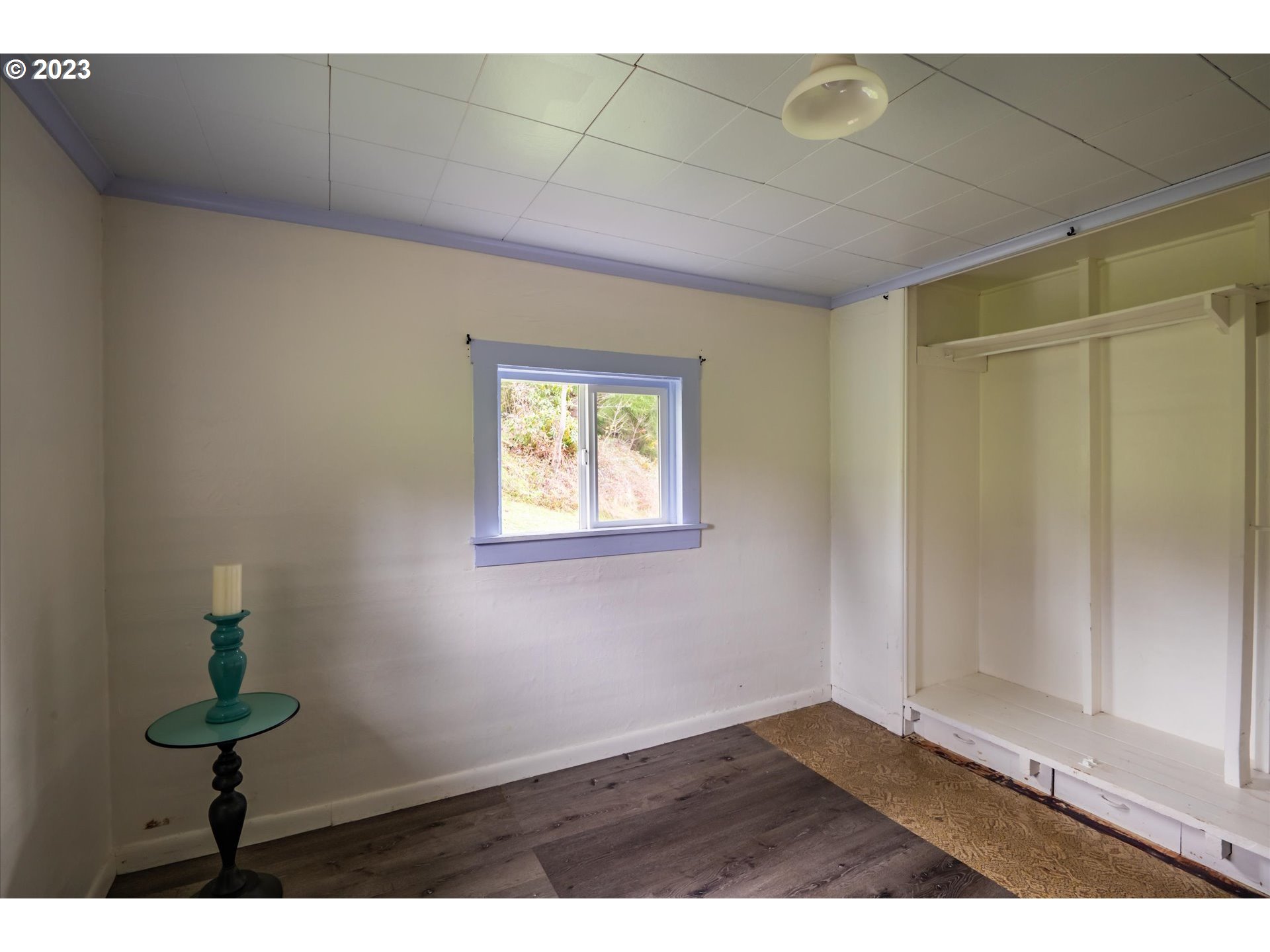 63657 Olive Barber Road Coos Bay, OR 97420 - Photo 13 of 34 a view of an empty room with window and wooden floor