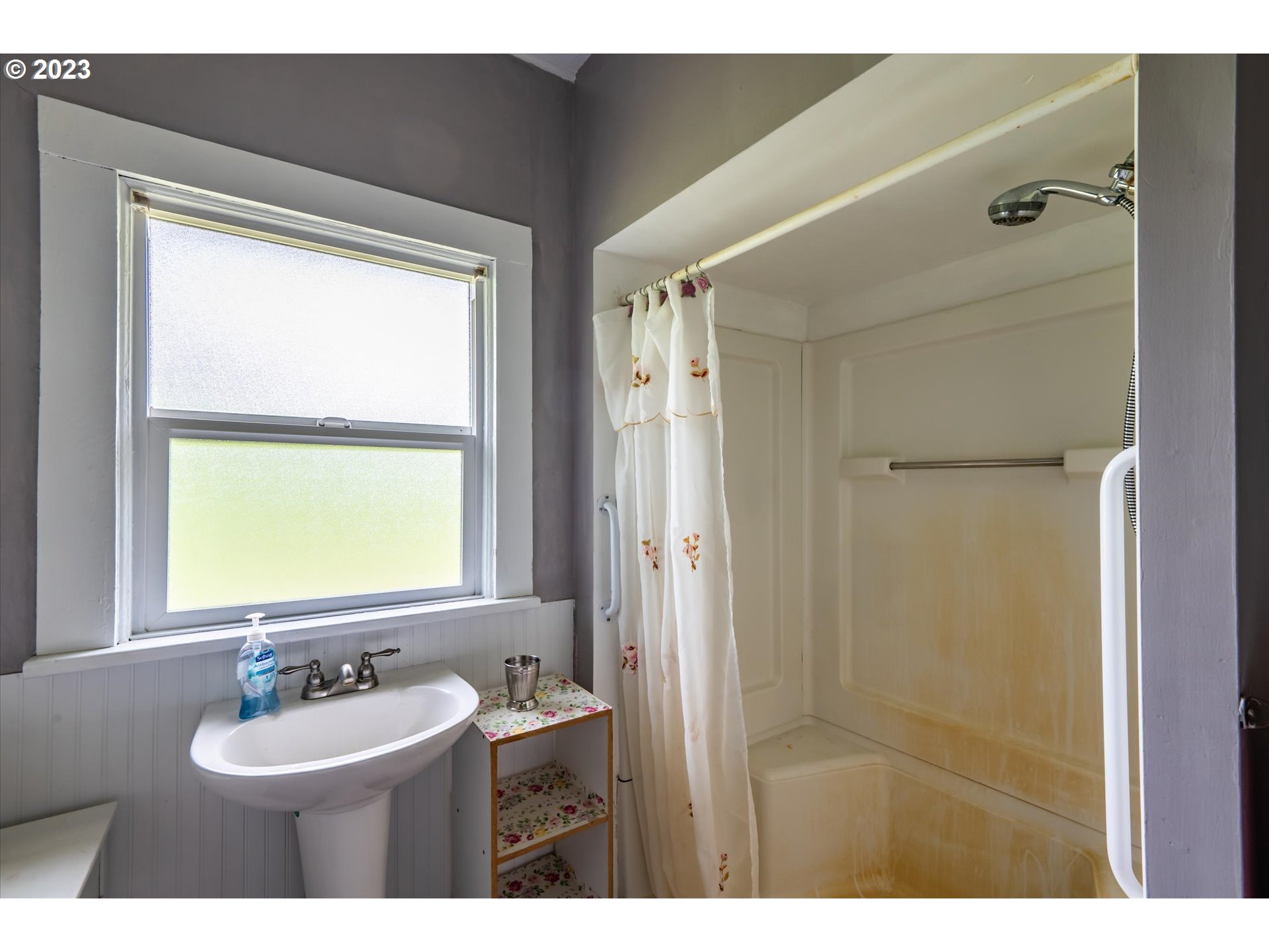 63657 Olive Barber Road Coos Bay, OR 97420 - Photo 17 of 34 a bathroom with a sink a two mirror and a window