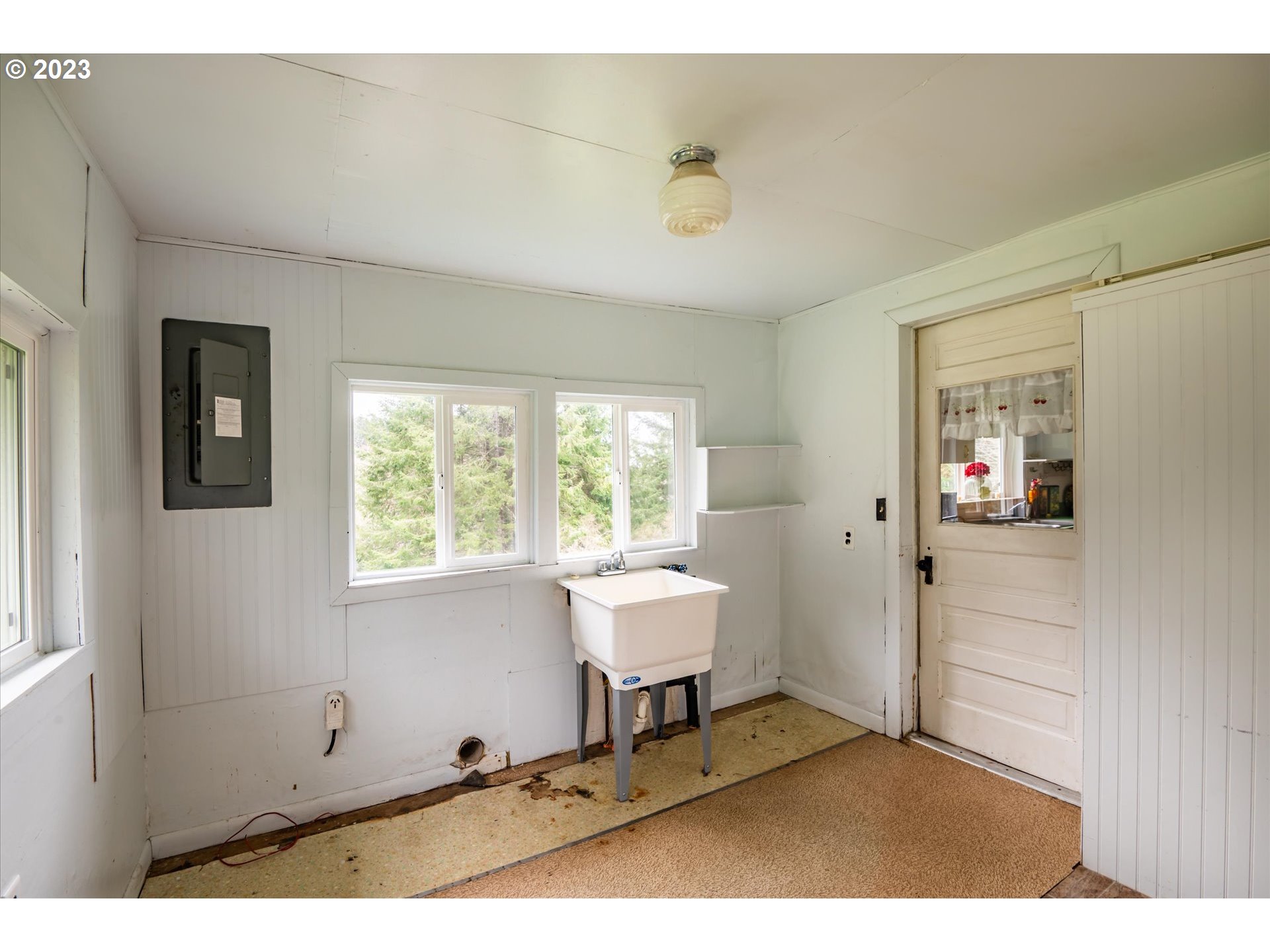 63657 Olive Barber Road Coos Bay, OR 97420 - Photo 19 of 34 a living room with a sink furniture and a window