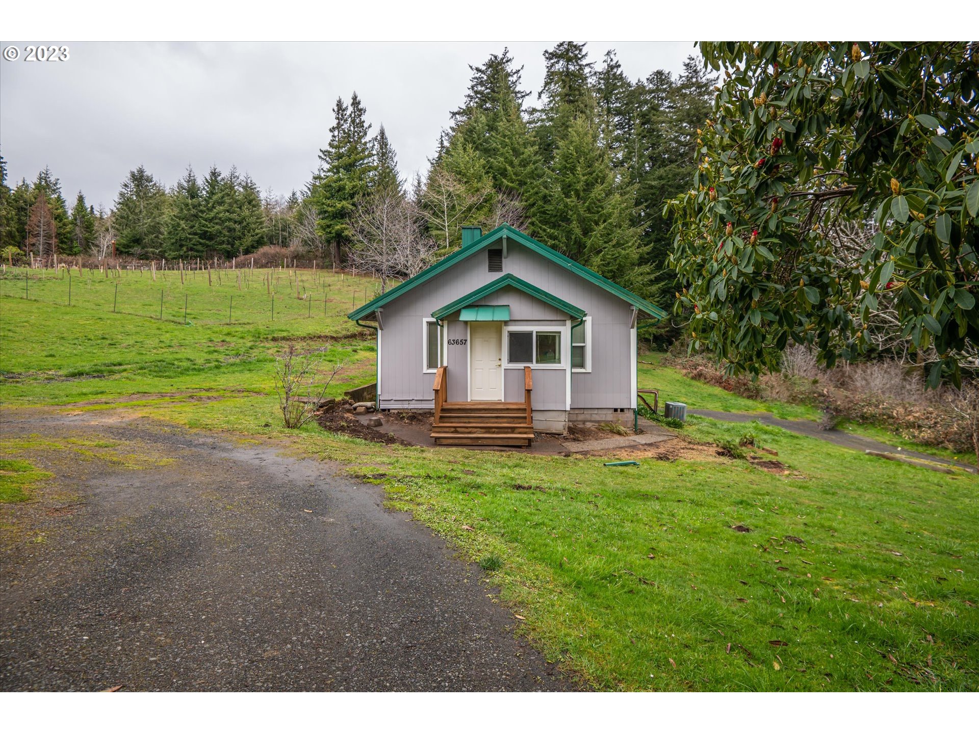 63657 Olive Barber Road Coos Bay, OR 97420 - Photo 21 of 34 a view of a house with a yard and sitting area