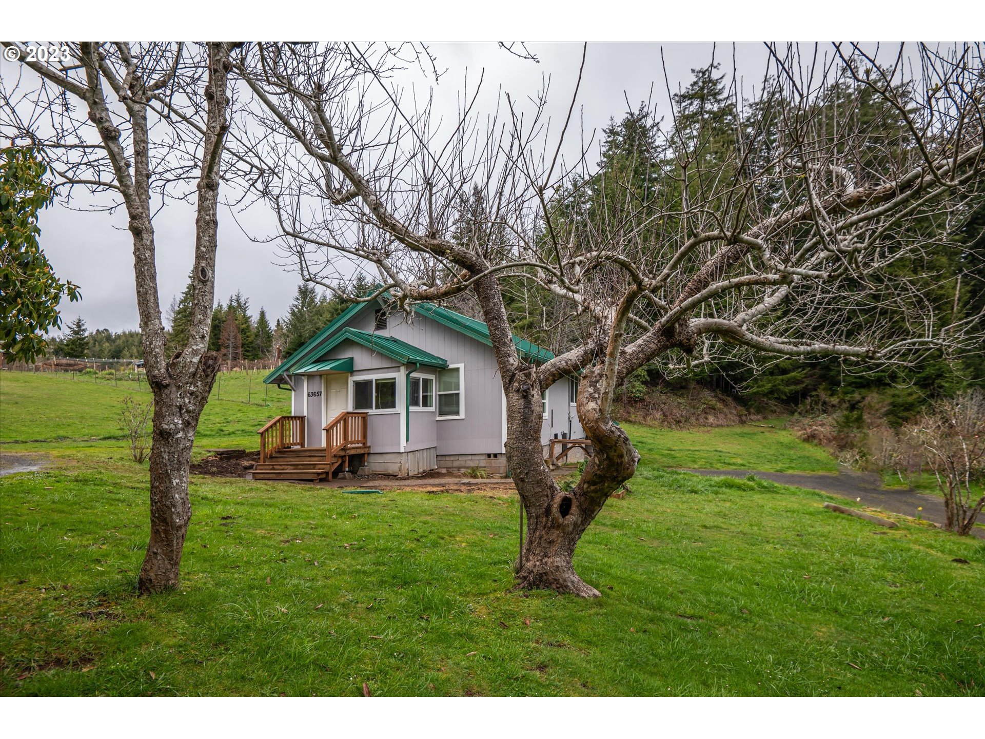 63657 Olive Barber Road Coos Bay, OR 97420 - Photo 22 of 34 a view of a house with a yard