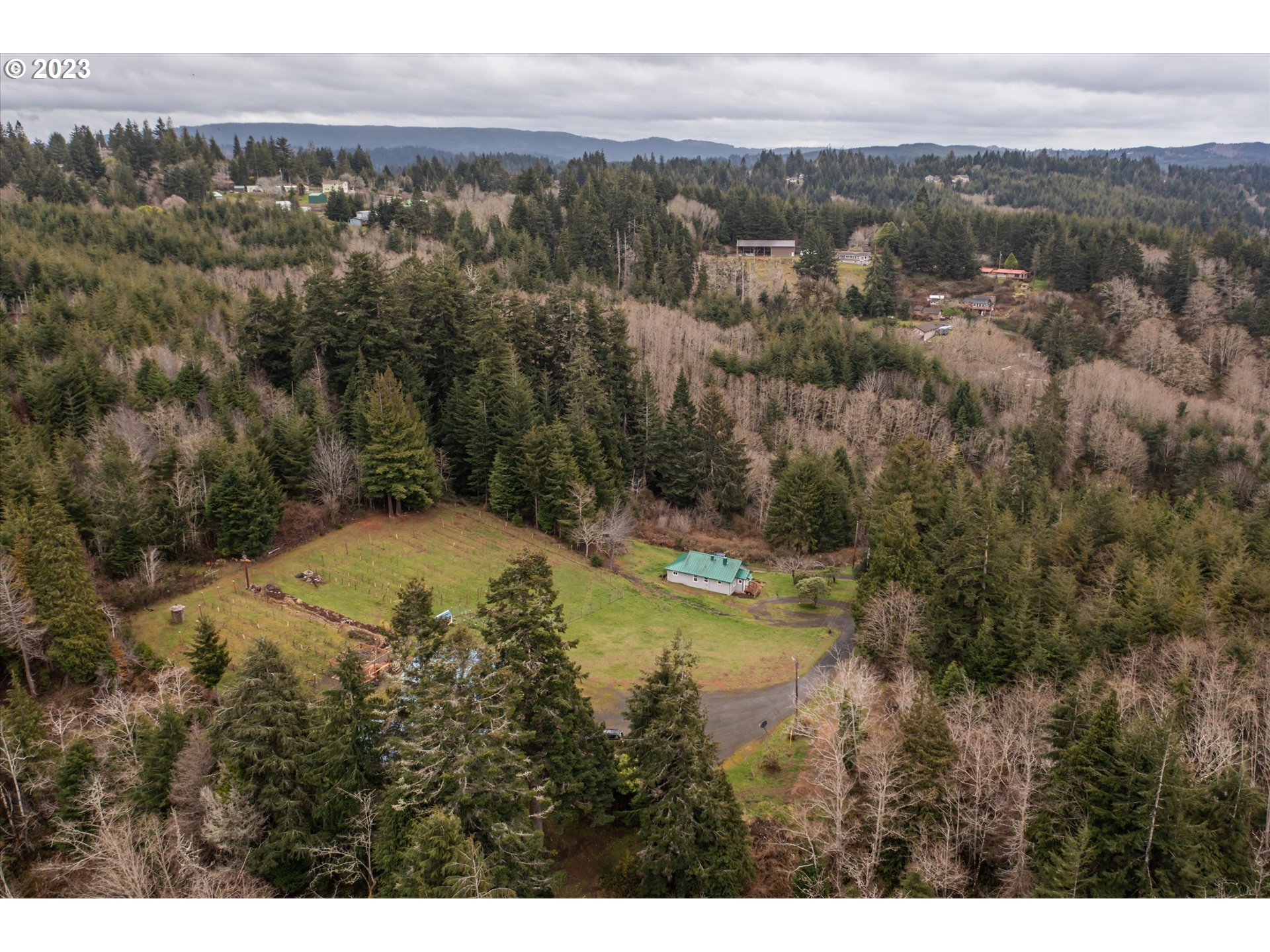 63657 Olive Barber Road Coos Bay, OR 97420 - Photo 3 of 34 a view of a lake with mountains and trees
