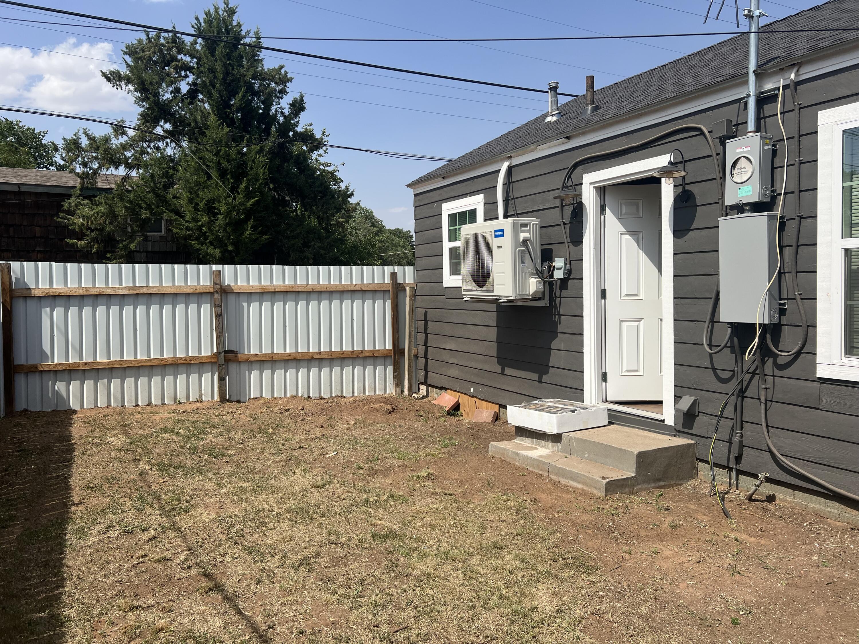 2202 28th Street, Unit B Lubbock, TX 79411 - Photo 12 of 17 a view of a house with a wooden fence