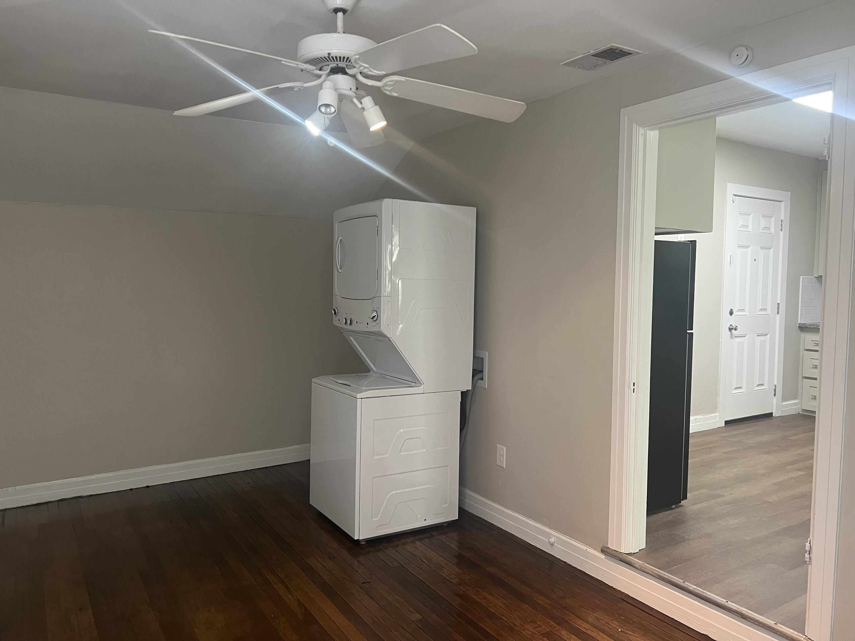 2202 28th Street, Unit B Lubbock, TX 79411 - Photo 3 of 17 en empty room with wooden floor and ceiling fan