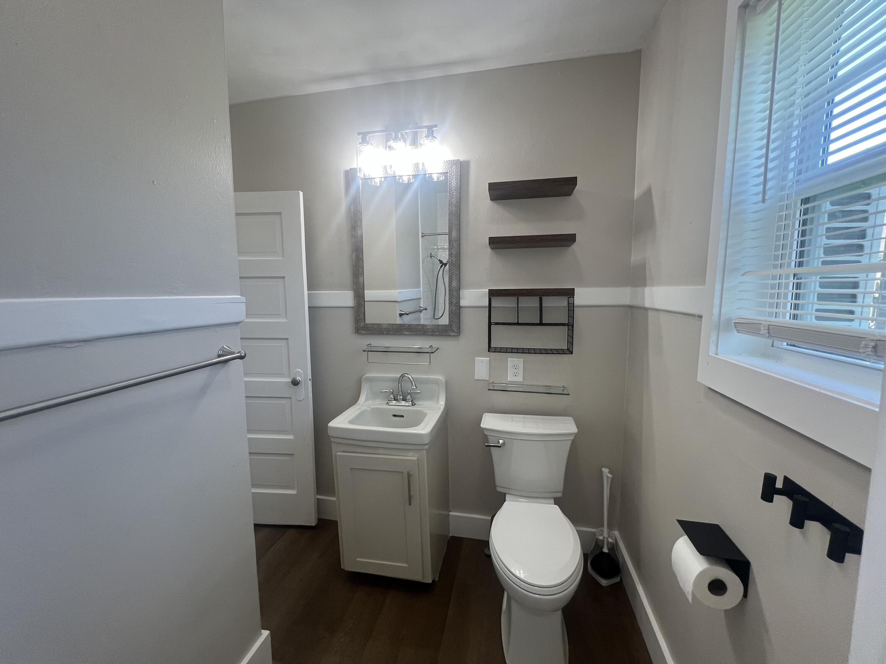 2202 28th Street, Unit B Lubbock, TX 79411 - Photo 7 of 17 a bathroom with a toilet sink and mirror