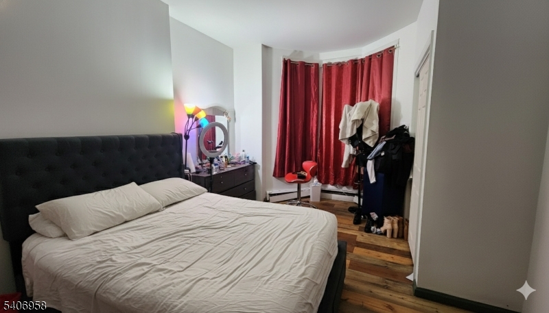 239 South 8th Street Newark, NJ 07103 - Photo 13 of 26 a bedroom with a bed and a closet