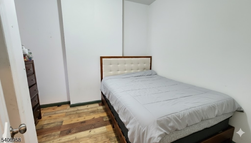 239 South 8th Street Newark, NJ 07103 - Photo 16 of 26 a bedroom with a bed and a mirror