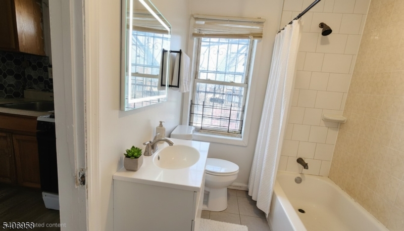 239 South 8th Street Newark, NJ 07103 - Photo 2 of 26 a bath room with a toilet a bath tub and a shower
