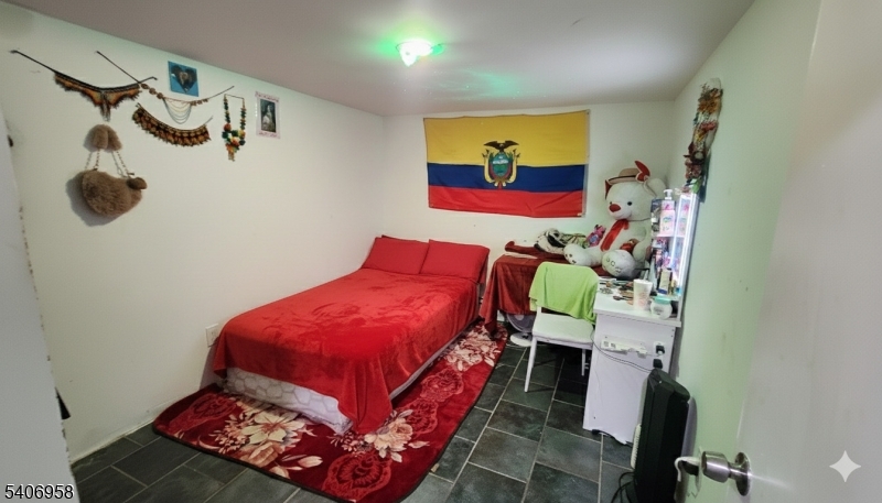 239 South 8th Street Newark, NJ 07103 - Photo 22 of 26 a bed room with a bed and a painting on the wall