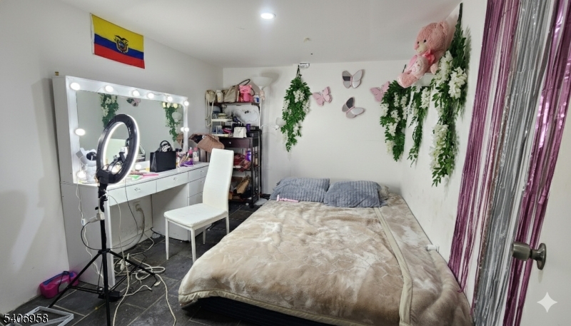 239 South 8th Street Newark, NJ 07103 - Photo 23 of 26 a bedroom with a bed and a dresser