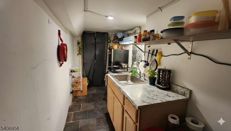 239 South 8th Street Newark, NJ 07103 - Photo 24 of 26 a kitchen with stainless steel appliances granite countertop a sink and a refrigerator