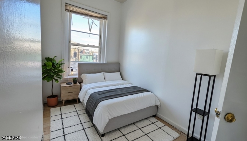 239 South 8th Street Newark, NJ 07103 - Photo 5 of 26 a bedroom with a bed and a window