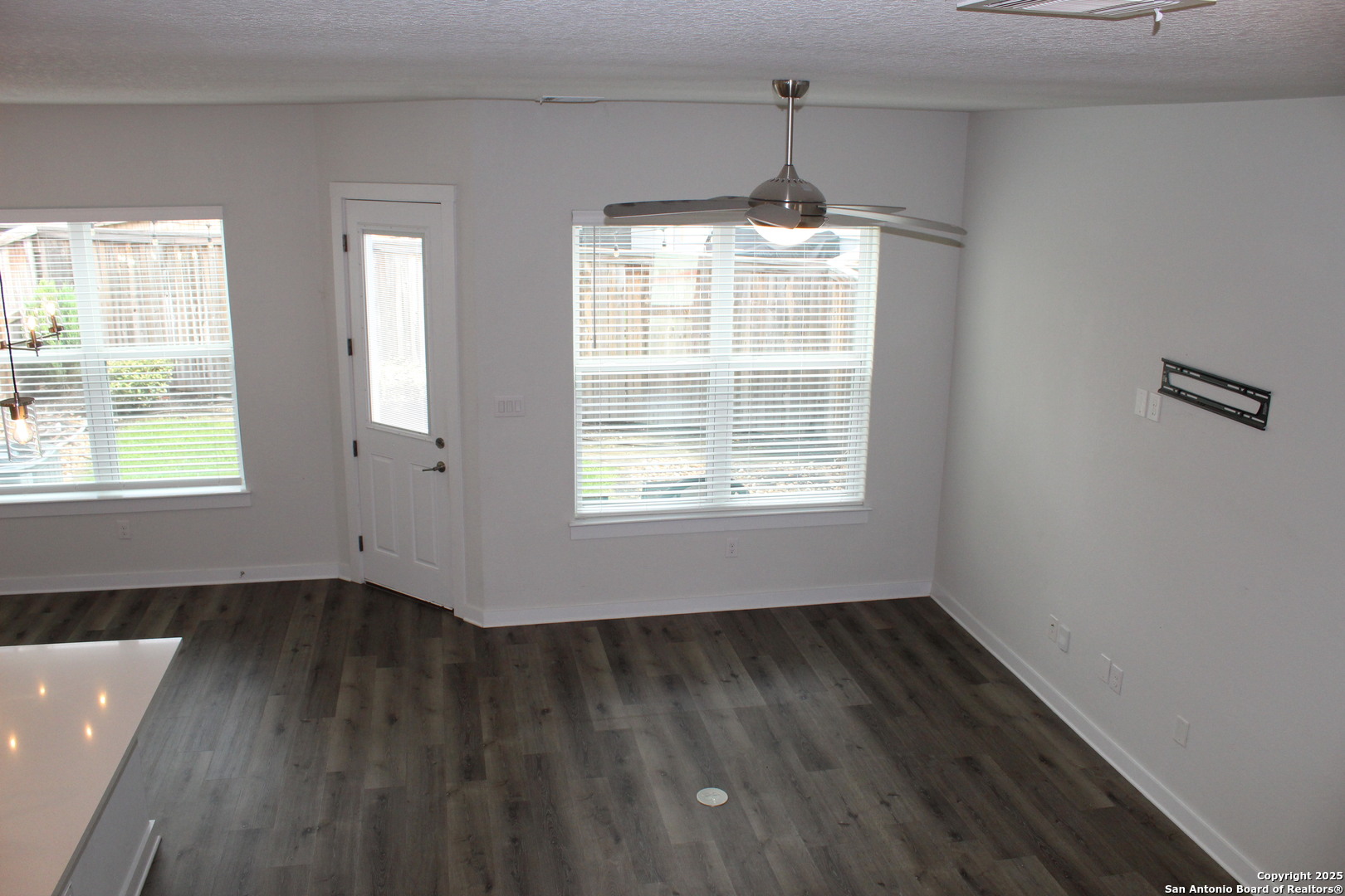 5843 Whitby Road, Unit 33 San Antonio, TX 78240 - Photo 4 of 15 a view of an empty room with wooden floor and a window