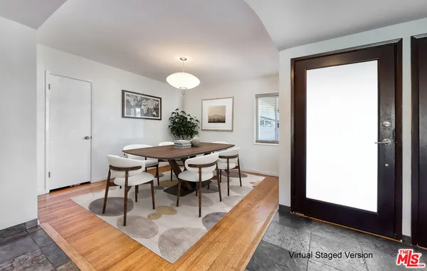 a dining room with furniture and a window