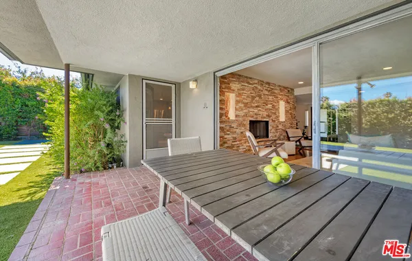 a view of a patio with a table chairs and a patio