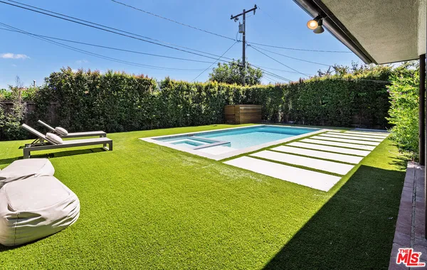 a view of a swimming pool with a patio