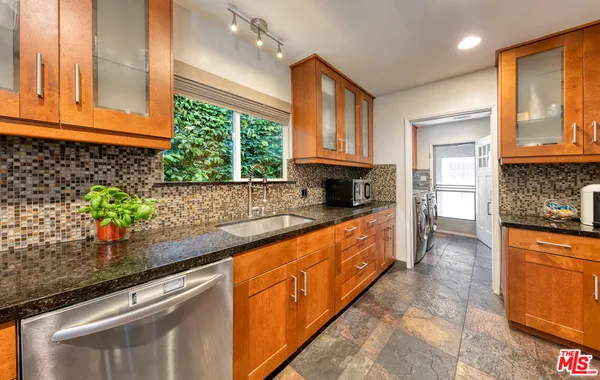 a view of a kitchen with washer and dryer