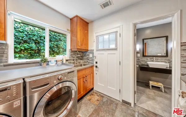 a bathroom with a shower sink vanity and mirror