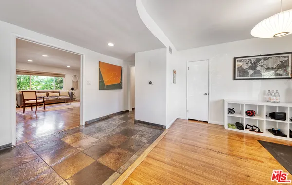 a view of a livingroom with furniture hardwood floor and a ceiling fan