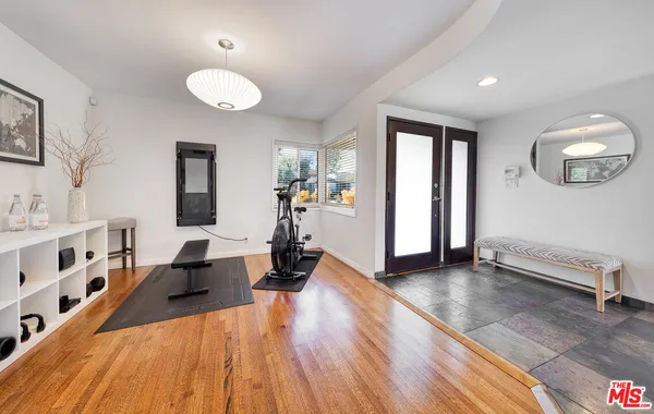 a view of a living room hardwood floor and a window